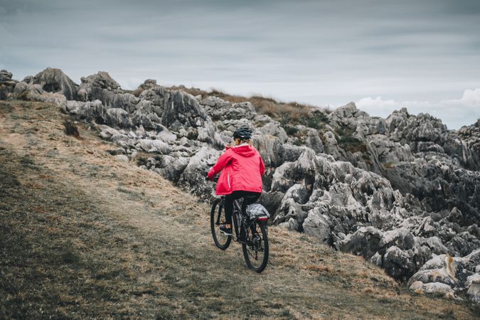 Female cyclist riding on mountain road