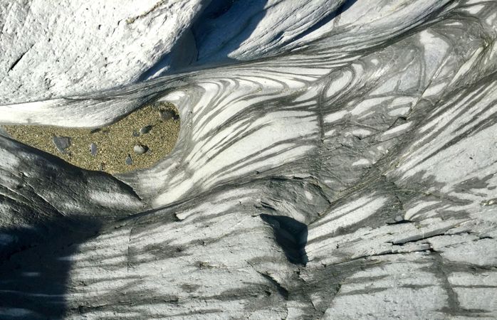 smooth rocks with wavy patterns eroded by the sea