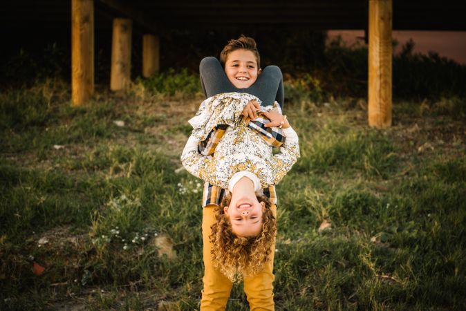 playful siblings at beach