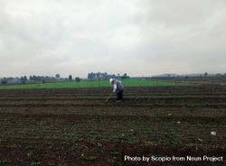 Side view of older man standing on agricultural land bYMPGb