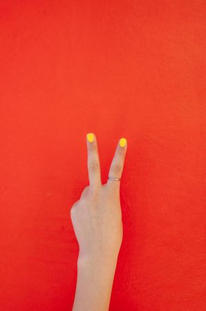 Close up of hand of a woman gesturing a peace sign with fingers
