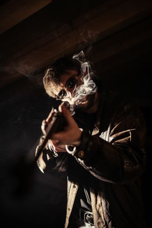 Man with shotgun and cigarette