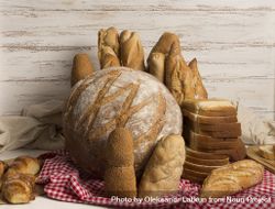 Assortment of bread loaves on a red tablecloth bepnK4