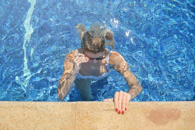 Woman in bikini in swimming pool alone