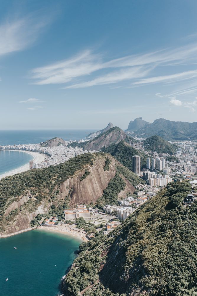 Aerial view of city surrounded by mountains and ocean