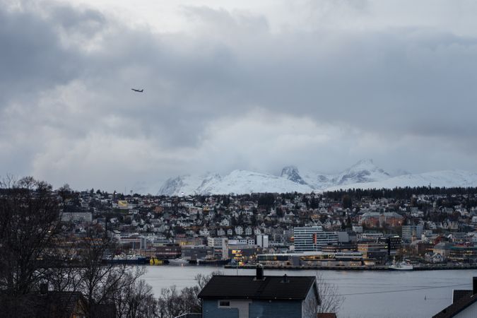 Wonderful cityscape against snowy highland in cold overcast weather