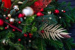 Christmas festive center piece with fir branches and gold & red ornaments
