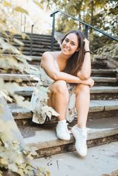 stylish woman sitting on stairs of park in New York