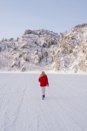 Frozen woman wrapped in scarf on winter day