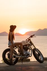 Woman with motorbike near sea