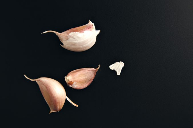 Garlic gloves on dark background