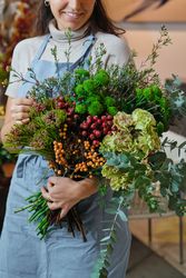 Crop woman with flower bouquet