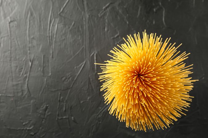 Pasta on dark background, space for text and top view