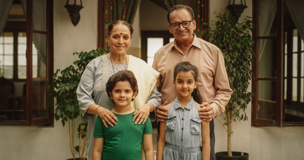 Portrait of Happy Indian Family Posing Together in Beautifully Authentic Mumbai House.