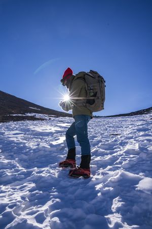 Tourist gazing at breathtaking snowy mountain slope