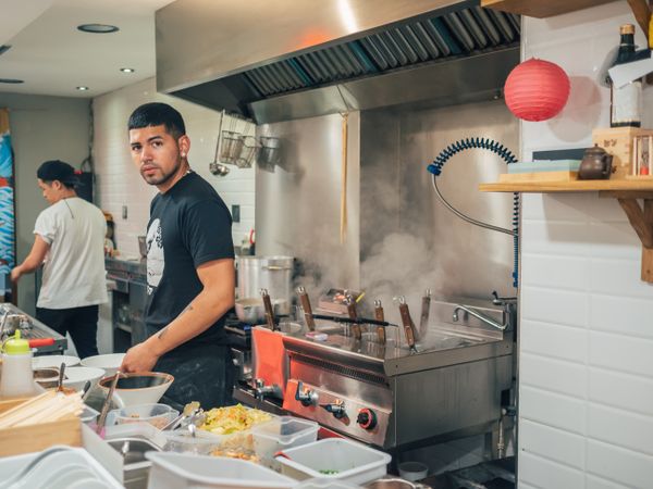 Young male working in Asian cafe