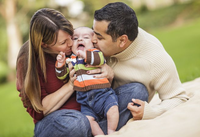Happy Parents Playing with Their Son