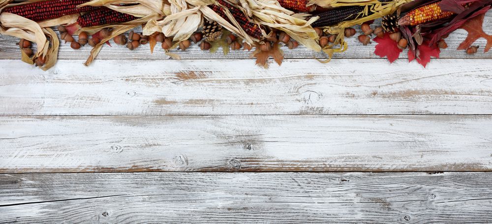 Top border of Autumn decorations on rustic wooden boards for the holiday season