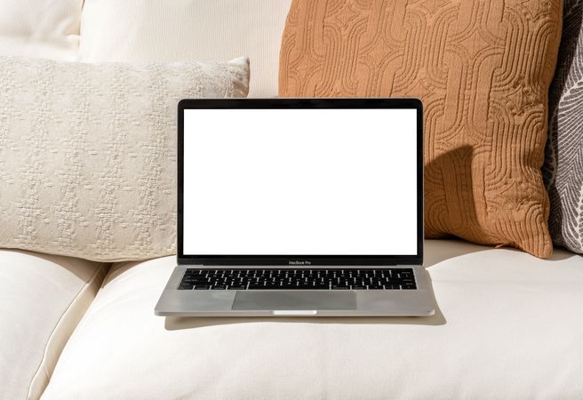 Laptop mockup on beige couch at home
