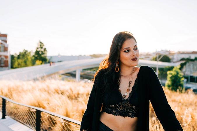 Trendy female standing on urban background