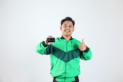 Asian Online Driver Holding Credit Card with Ok Gesture