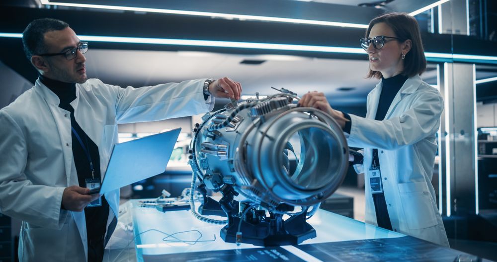 Professional Multicultural Team of Female and Male Engineers Working On Industrial Jet Turbine