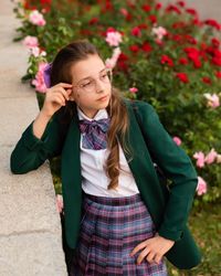 Young girl in school uniform looking thoughtfully