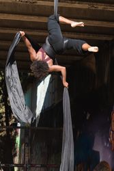 woman doing aerial yoga in city