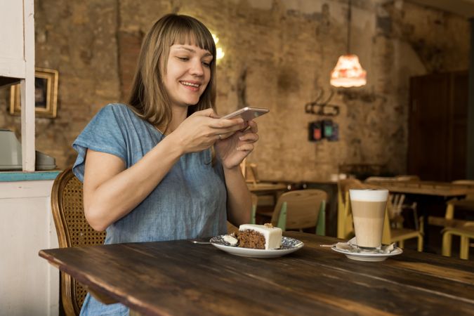 Woman holding spoon with slice of cake