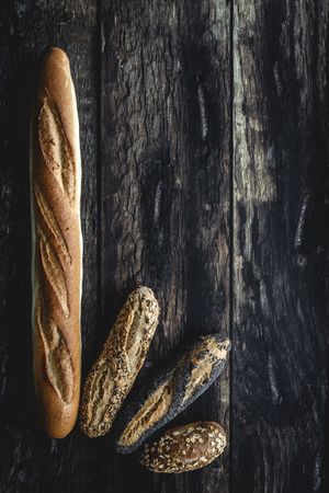 Assorted gold homemade bread on dark wood background