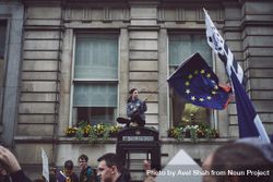London, England, United Kingdom - March 23rd, 2019: Woman waving EU flag sitting atop a phone booth 432rP5