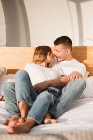Passionate couple hugging on bed of bubble room
