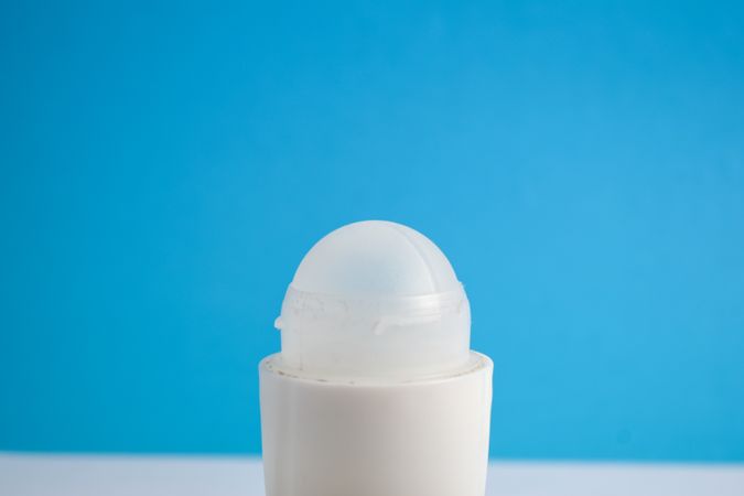 Top of deodorant bottle on blue background