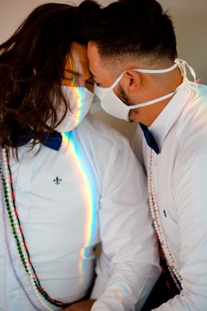 Two men with facemasks hugging each other