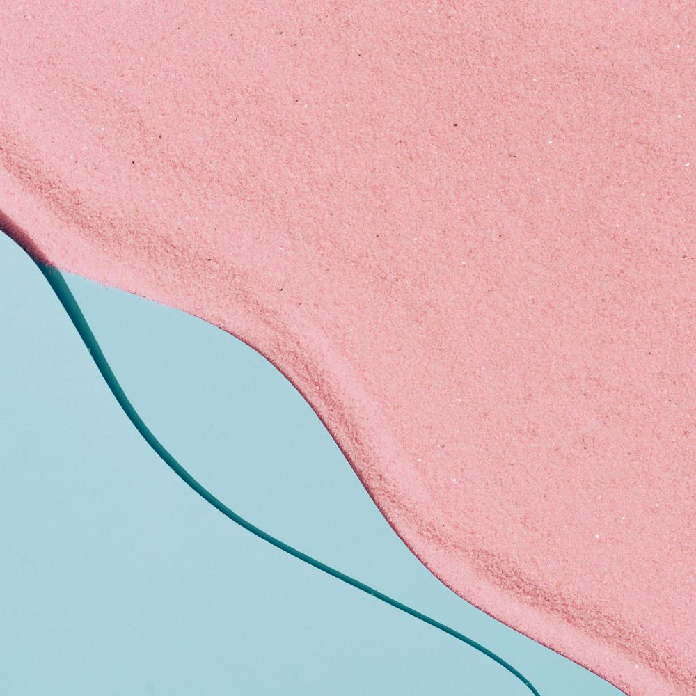 Pink sand and blue water beach scene