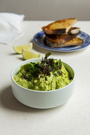 Guacamole in a light green bowl