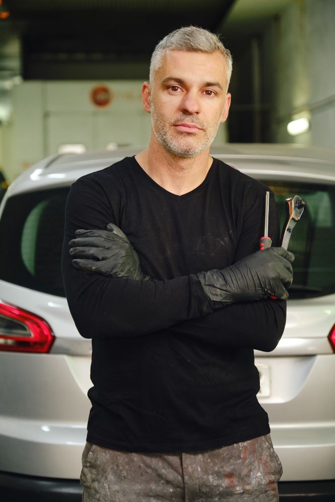 Confident mechanic in garage