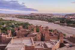 Ancient city near river in desert and wonderful sky