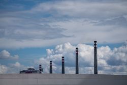 Industrial smoke stacks and beautiful cloudy sky
