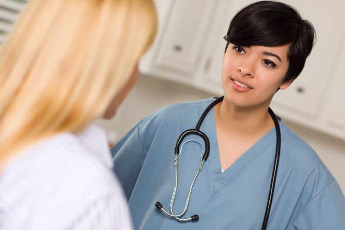 Young Female Doctor Talking with Patient