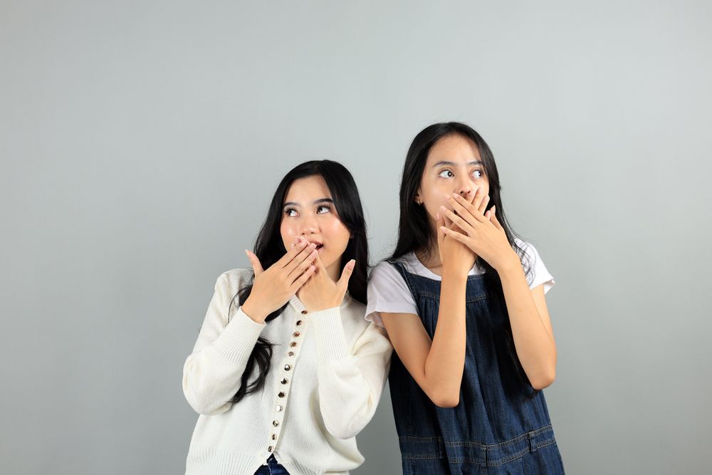 Two Asian Young Girl Shocked and Covering Her Mouth