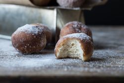 Baked cakes in craft paper on table
