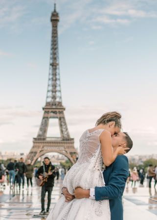 Happy newlyweds in wedding clothing kissing