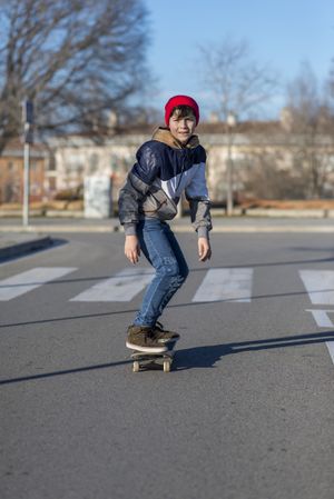Young man riding on a skateboard on city street
