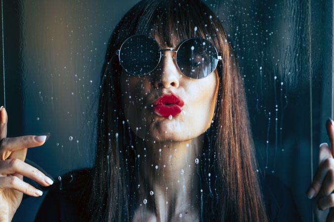 Stylish woman kissing glass