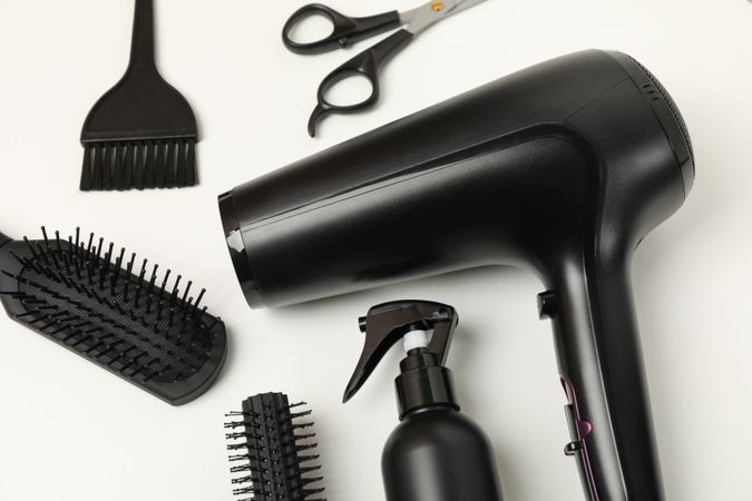Composition with hairdresser accessories on blank background
