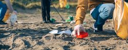 Young man cleaning the beach