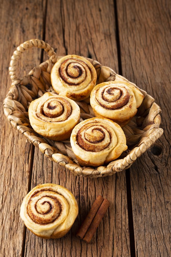 Cinnamon rolls on wooden background.