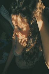 Top view of woman in gray bra with floral shadow on her