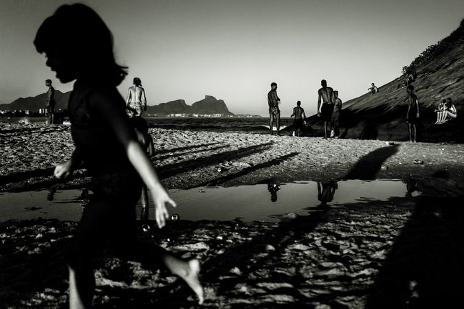 Grayscale photo of people at the beach